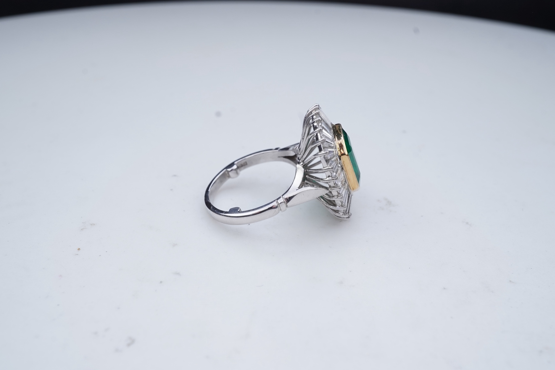 An emerald and diamond ring